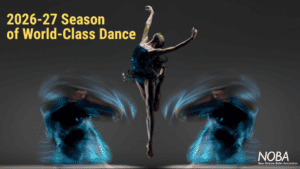 Ballet dancer performing leap with dynamic blue light effects.